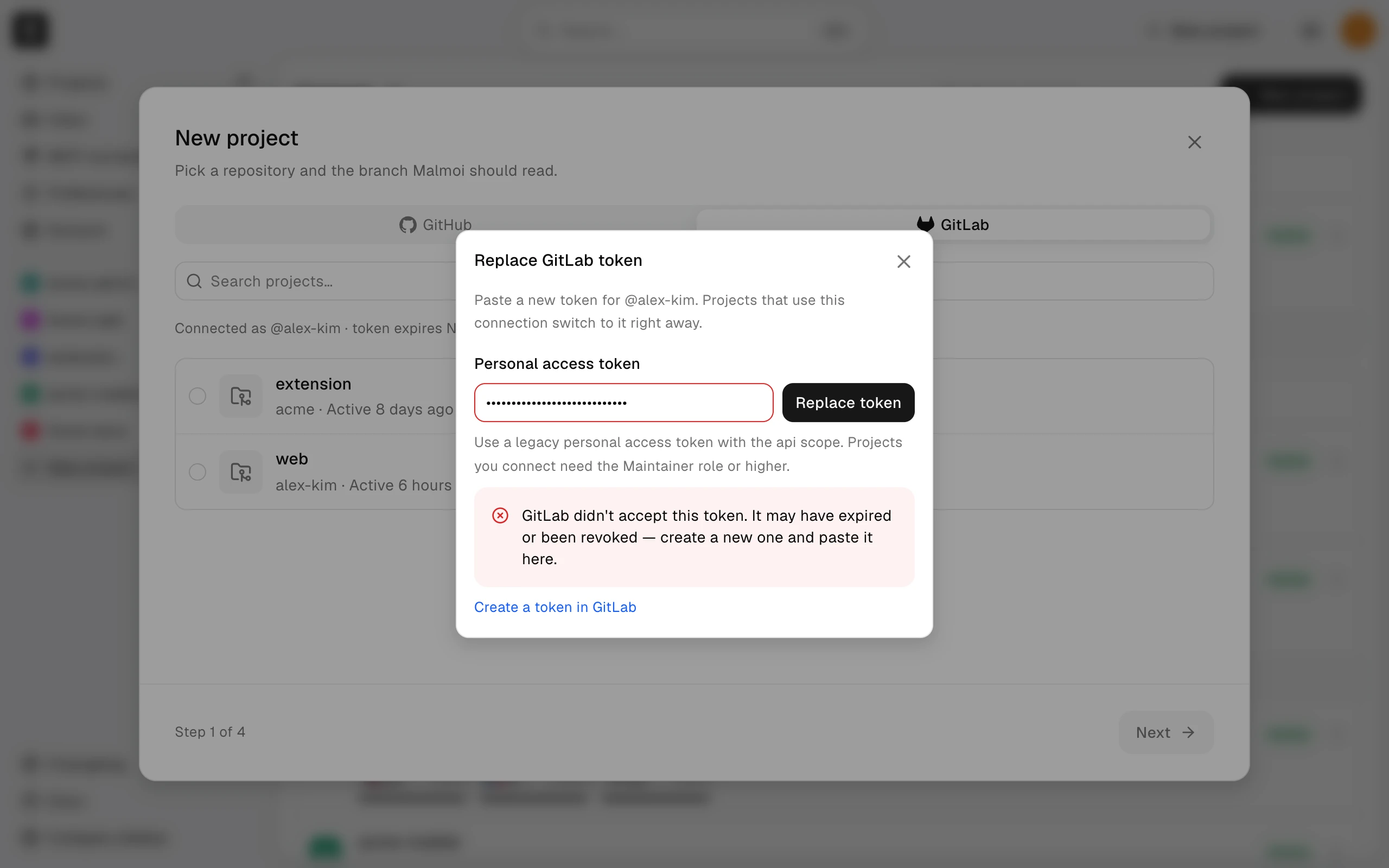 The Replace GitLab token dialog with a pasted token and an error saying GitLab didn't accept it
